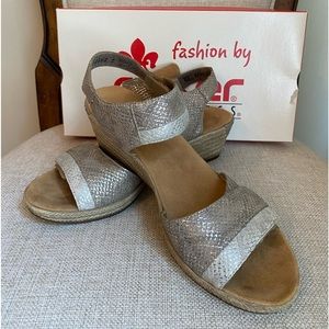 Women’s Rieker metallic wedge sandal with Velcro closure and a 2” heel. Size 8